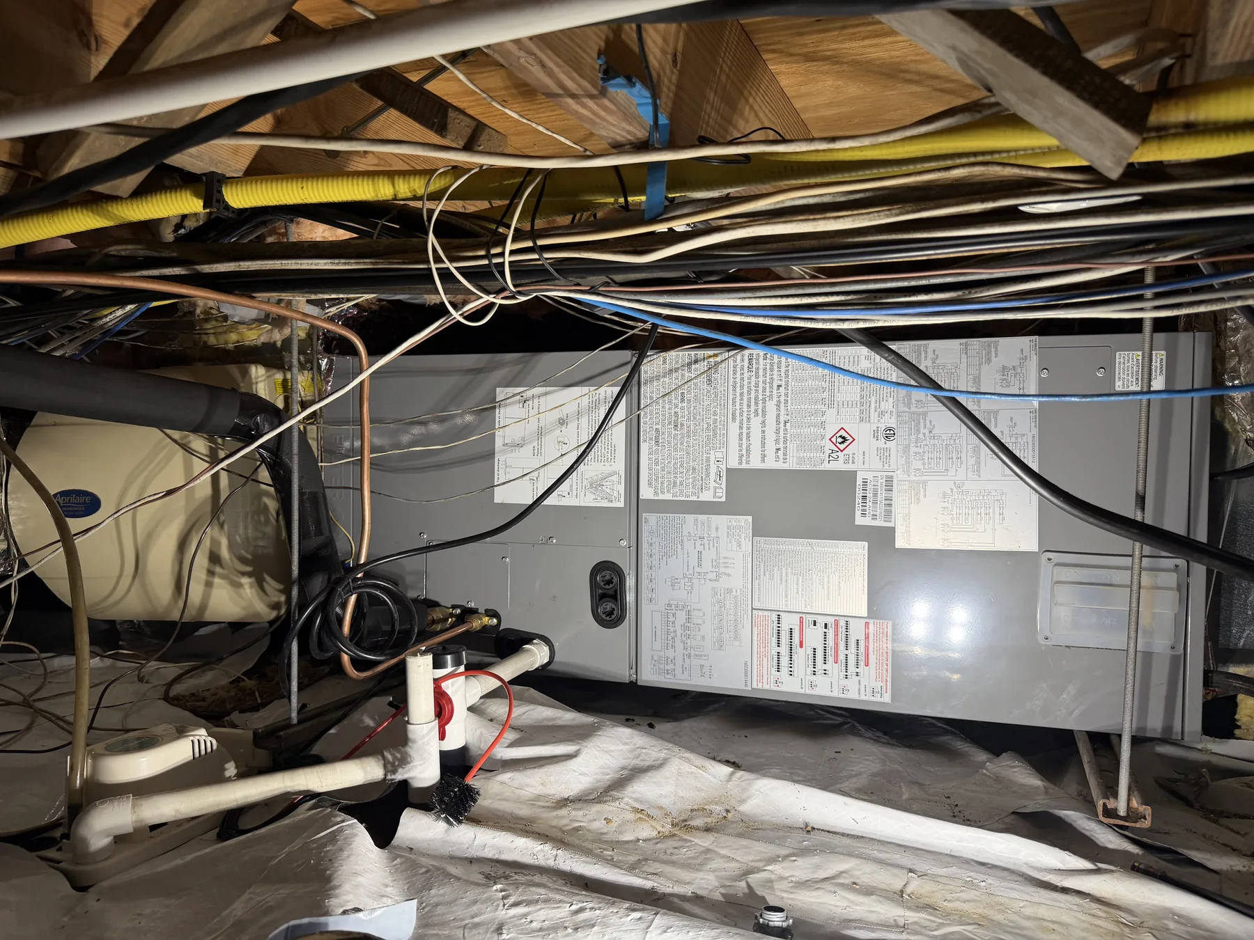 Commercial air handler and piping above a ceiling space
