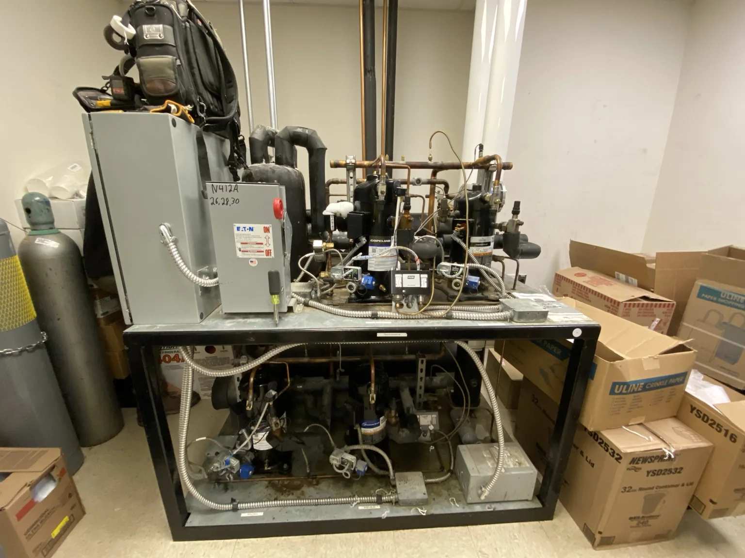 Commercial refrigeration equipment rack with compressors and piping